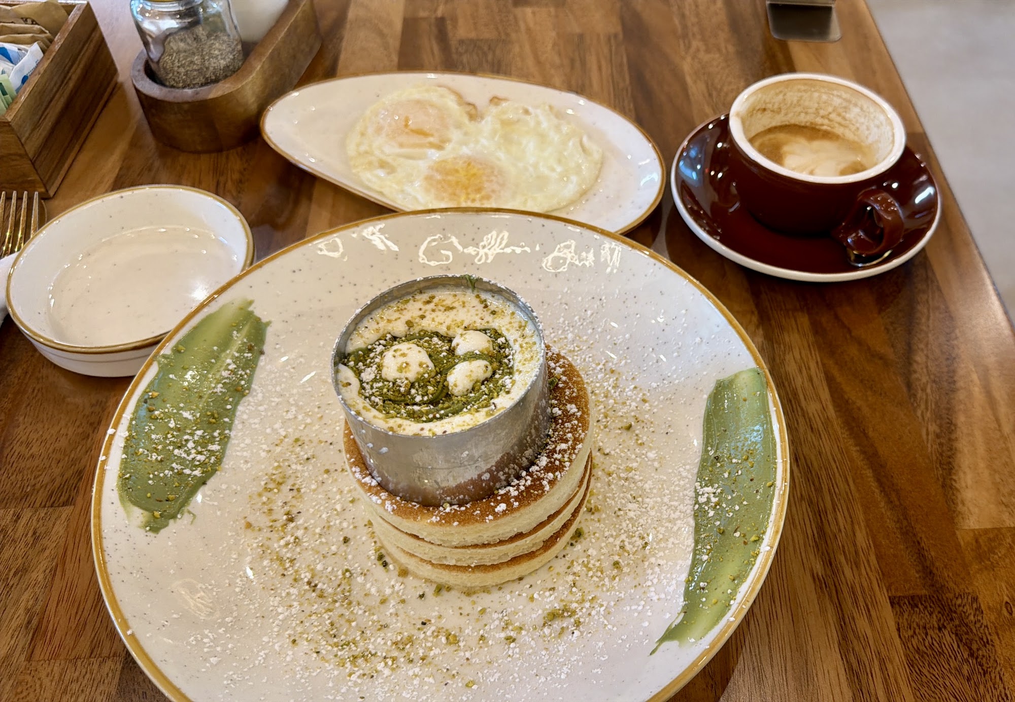 Dessert plate and coffee on a wooden café table
